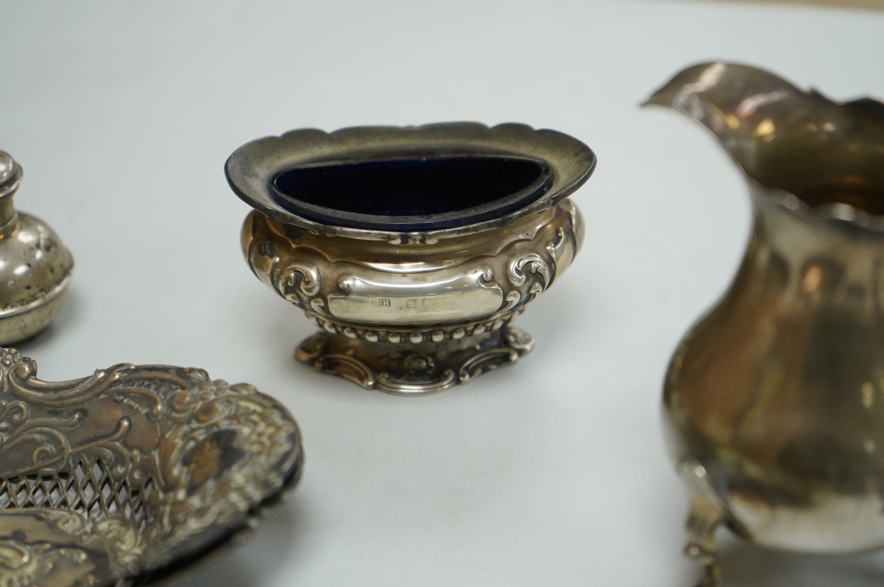 A collection of small silver, including a George III cream jug, London, 1762, 88mm, a George V sugar caster, small five bar toastrack, pair of bonbon dishes, pepperette, dish, two condiment spoons and mustard pot, togeth
